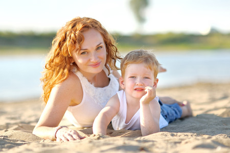Happy Mom and baby son in summer natureの写真素材