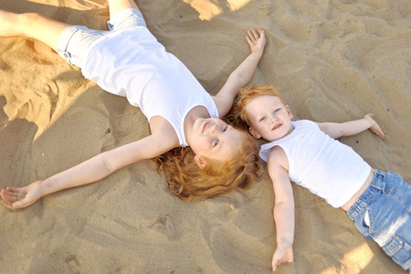 Portrait of a boy and girl on the beach in summerの写真素材