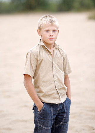 Portrait of a little boy on the beach in summerの写真素材