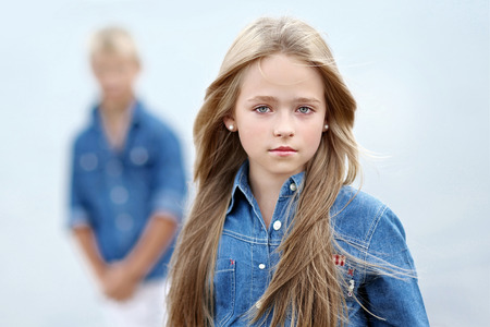 Portrait of a boy and girl on the beach in summerの写真素材