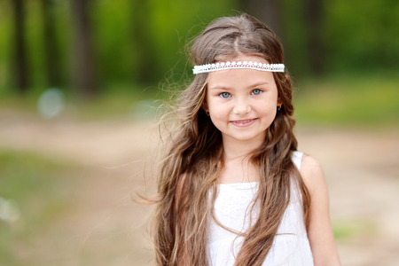 portrait of a beautiful little girl in summerの写真素材