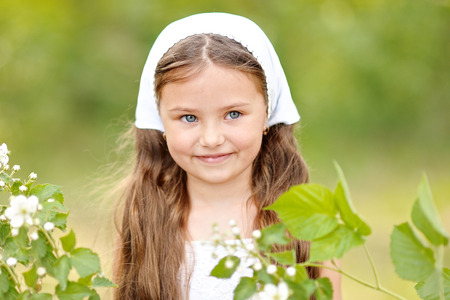 portrait of a beautiful little girl with flowersの写真素材