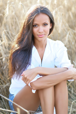beautiful elegant brunette girl in a fieldの写真素材