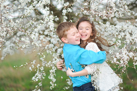Portrait of a boy and girl in the lush gardenの写真素材