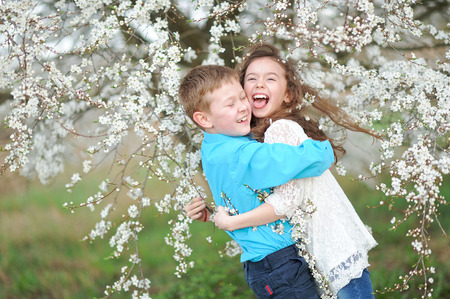 Portrait of a boy and girl in the lush gardenの写真素材