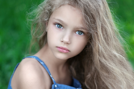 portrait of little girl outdoors in spring;の写真素材