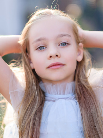 portrait of little girl outdoors in summer
