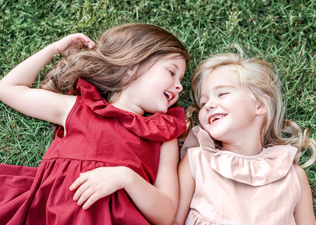 portrait of two girls of girlfriends on a summer natureの写真素材