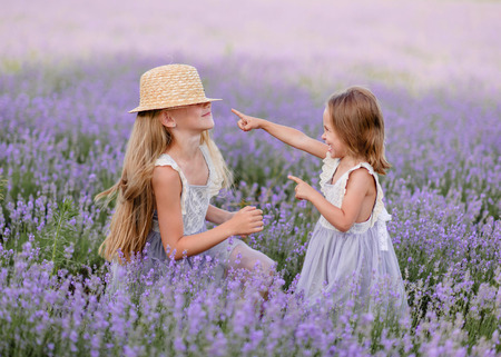 portrait of two sisters in a lavender fieldの写真素材