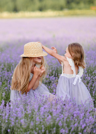 portrait of two sisters in a lavender fieldの写真素材