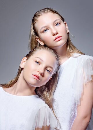 portrait of two sisters twins in the studioの写真素材