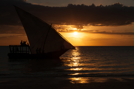 Silhouette of a sailboat in the Indian Ocean on the background of a beautiful sunsetの写真素材