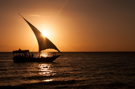 Silhouette of a sailboat in the Indian Ocean on the background of a beautiful sunset