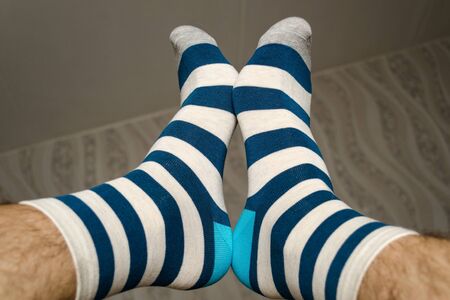 men's legs in blue-striped socksの写真素材