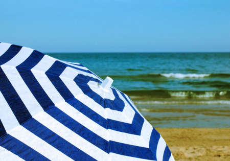 beach umbrella on the bank of Mediterranean sea in Spainの写真素材