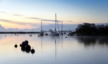 Boats and early morning mist at Christchurch harbour in Dorsetの写真素材