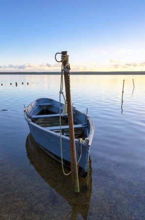 Blue boat moored at the Fleet lagoon near Weymouth in Dorsetの写真素材