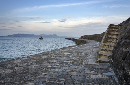 A winters day at The Cobb part of the historic harbour of Lyme Regis on the Jurassic Coast in Dorsetの写真素材