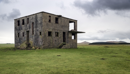Abandoned and derelict control tower at WWII airbase at Davidstow Moor on Bodmin Moor near Camelford with Roughtor in the distanceの写真素材