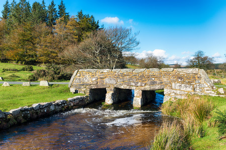 An old stone bridge over Walla Brook near Bellever on Dartmoor National Park in Devonの写真素材