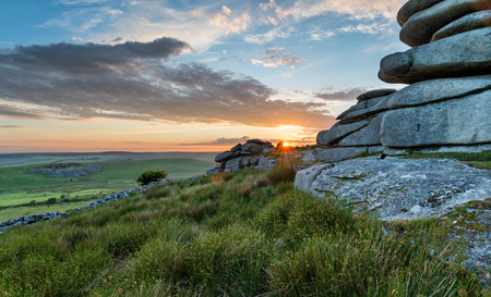 Beautiful sunset over a granite tor at the Cheesewring on Stowes Hill near the Minions on Bodmin Moor in Cornwallの写真素材