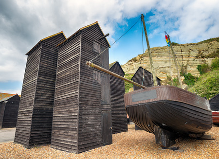 Tall thin traditional wooden fishing net huts on the harbour at the Stade in Hastings, East Sussexの写真素材