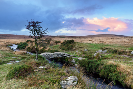 A small granite clapper bridge over Gallaven Brook at Scorhill on Dartmoor National Park in Devonの写真素材