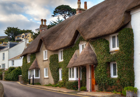 Pretty thatched cottages at the seaside town of St Mawes near Falmouth in Cornwallの写真素材