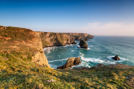 The South West Coast Path as it crosses Pentire Steps on the North Cornish coast looking out to the...