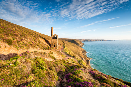 Old tin mining ruins from a bygone age on the South West Coast Path as it travels past the Towanroath engine house near St Agnes in Cornwallの写真素材