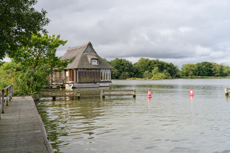 A thatched boat house on the Norfolk Broads at Malthouseの写真素材