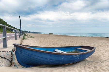 A rowing boat on the beach at Bournemouth on the Dorset coastの写真素材
