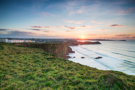 Stunning sunset over Porth on the coast at Newquay in Cornwallの写真素材