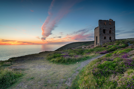 Dramatic sunset over the ruins of the Towanroath engine house on the South West Coast path at St Agnes in Cornwallの写真素材