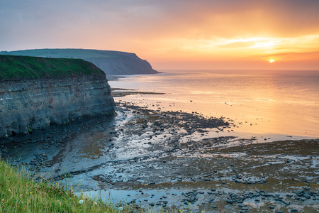 Sunset from the steep cliffs at Staithes on the Yorkshire coastの写真素材
