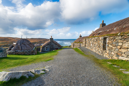 Traditional thatched crofts at Gearrannan Blackhouse Village at 	Carloway on the Isle of Lewis in the Outer Hebrides in Scotlandの写真素材