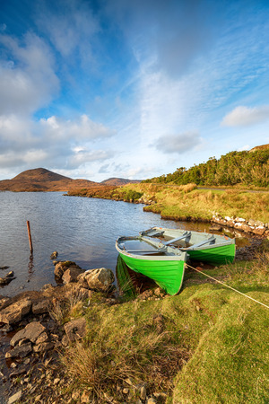 Rowing boats on the loch shore on the Golden Road on the Isle of Harris in the Outer Hebridesの写真素材