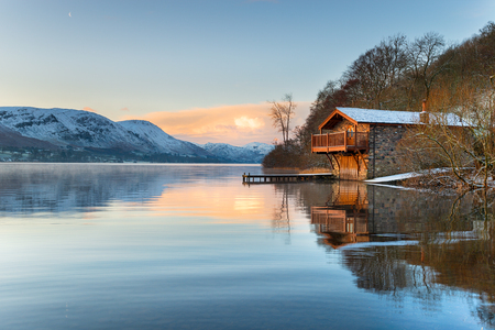 Sunrise at the old boathouse at Pooley Bridge on the shores of Ullswater in the Lake District in Cumbriaの写真素材