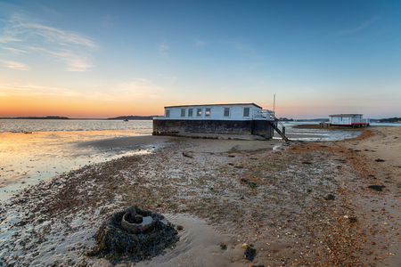 Boats on the shore at Bramble Bush bay on Studland on the Dorset coastの写真素材