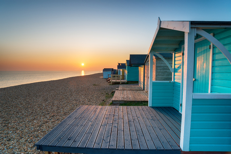 Sunset over beach huts at Milford on Sea in Hampshireの写真素材