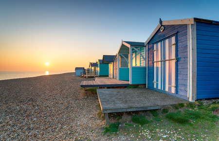 Beautiful sunset over beach huts at Milford on Sea on the Hampshire coastの写真素材