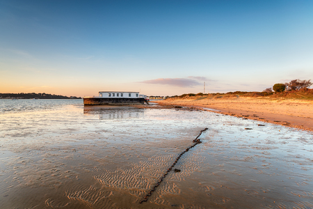 A houseboat at Bramble Bush Bay by the Sandbanks ferry crossing on the Studland peninsula on the Purbeck coast of Dorsetの写真素材