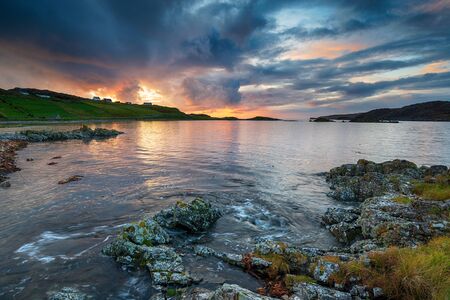 Dramatic sunset sky over the beach at Scourie in the Highlands of Scotlandの写真素材