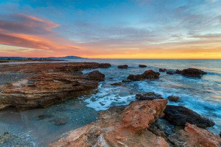 Sunrise over the Spanish coast at Torre La Sal near Valenciaの写真素材