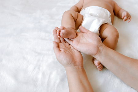 the newborn beautiful child lies on a white background