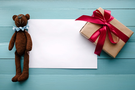 The teddy bear lies on a wooden backgroundの写真素材