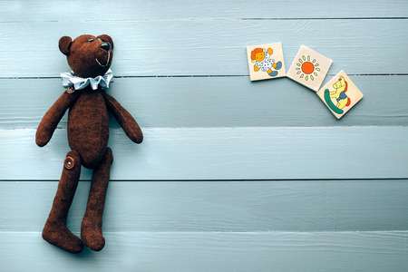 The teddy bear lies on a wooden backgroundの写真素材