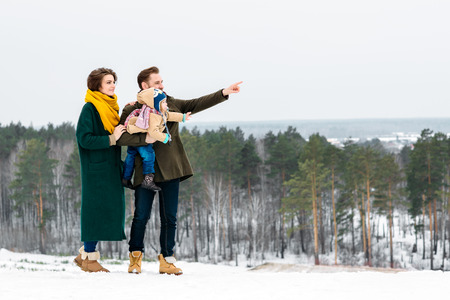 The beautiful and happy family walks in the winter outdoorsの写真素材