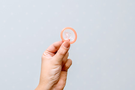 the photo of condom on the girl's handの写真素材