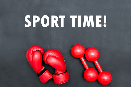 Boxing gloves and dumbbells on black backgroundの写真素材